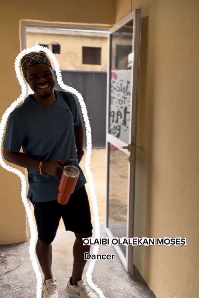 Casual portrait of Olaibi smiling at the studio entrance